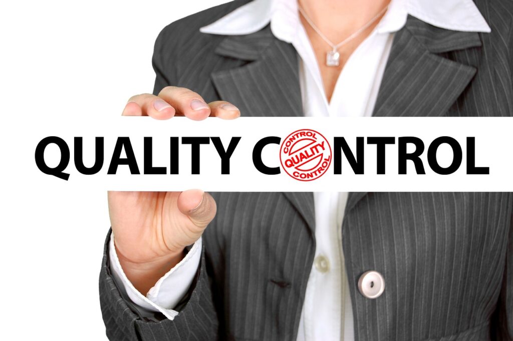 Woman holding quality control sign